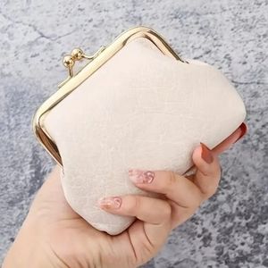 Cream colored vintage styled coin purse kiss lock closure